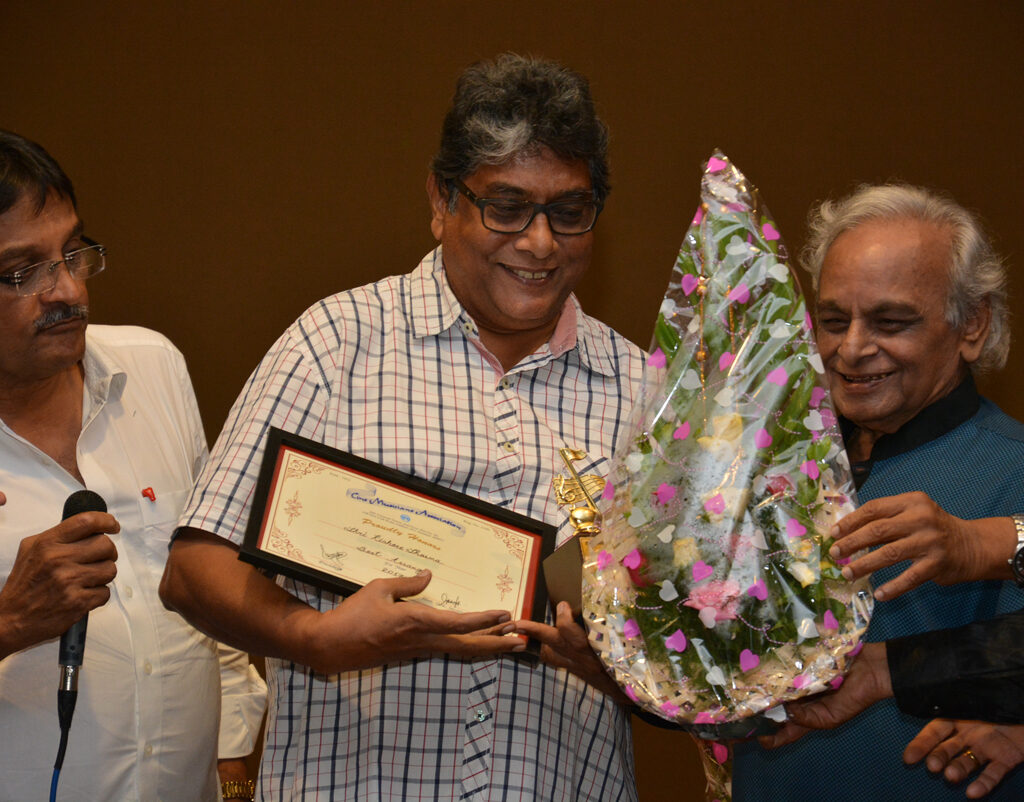 Celebrated music arranger Shri Kishore Sharma being awarded by Shri Anand ji