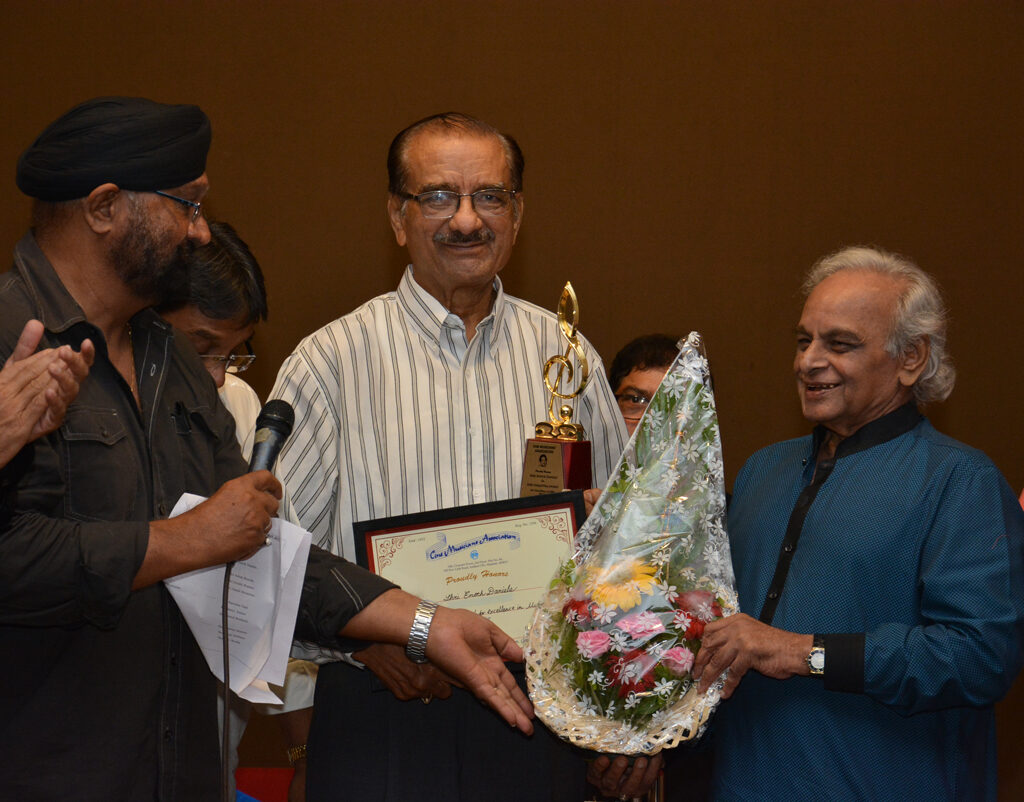 Famous arranger Shri Enoch Daniels being felicitated by Shri Anadji Bhai