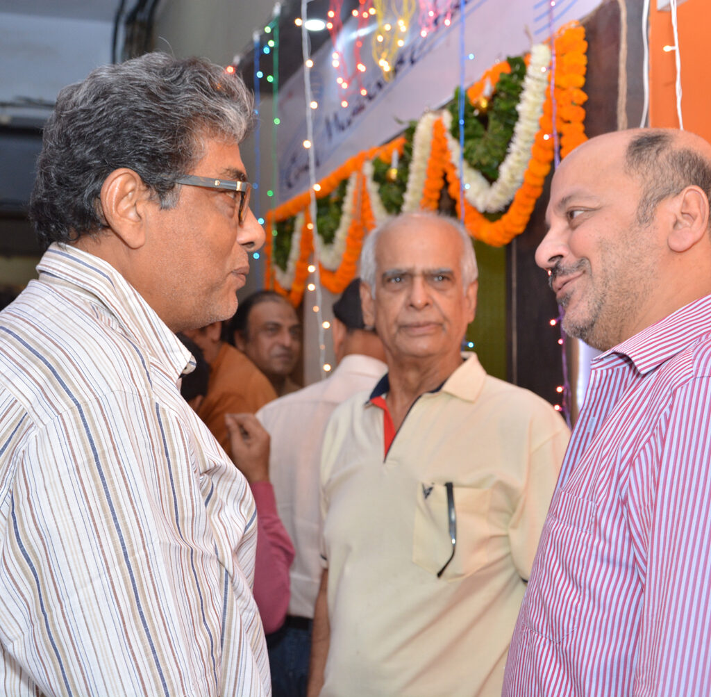 Animated conversation among members at the new office opening ceremony